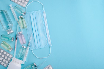 Syringe, pills, vial, and mask